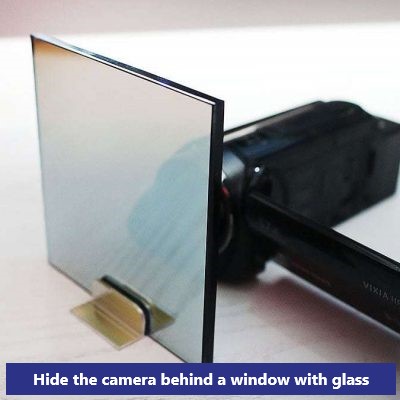 Hide the camera behind a window with glass