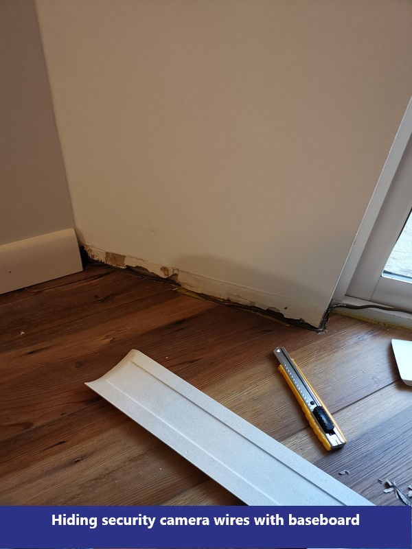 Hiding security camera wires with baseboard